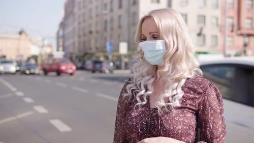 Woman Wearing Face Mask Gives Thumbs Down