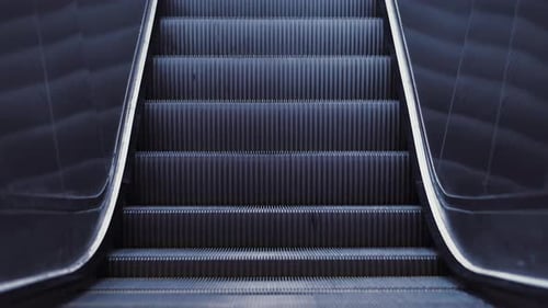 Automatic Stairs of Escalator Moving Up in Shopping Mall Without People.