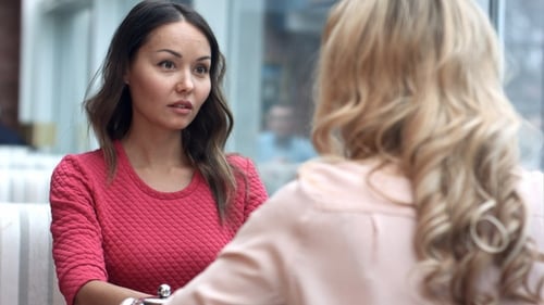 Women Talking and Connecting at Outdoor Cafe