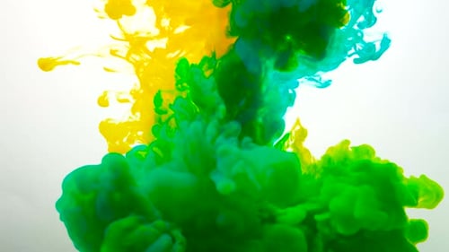 Mixed Yellow and Blue Liquid Ink Clouds Form Bright Green