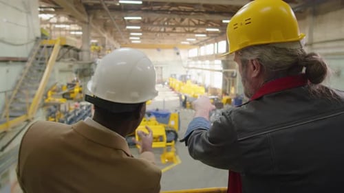 Factory Engineer and Technician Discussing Manufacturing Process