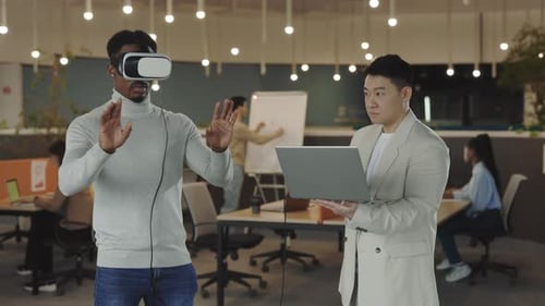 Man Experiencing VR with Colleague in Office