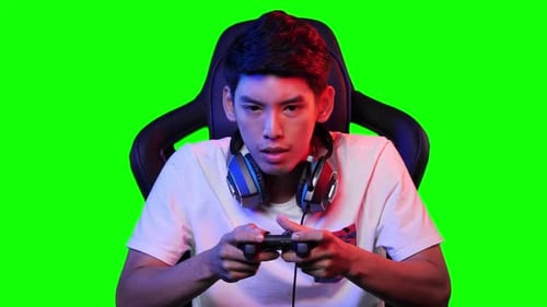 Young Man Playing Video Game on Green Screen
