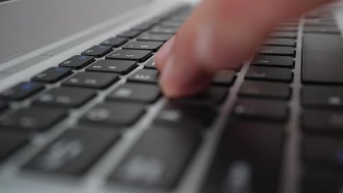 Fingers Typing on Laptop Keyboard Close Up