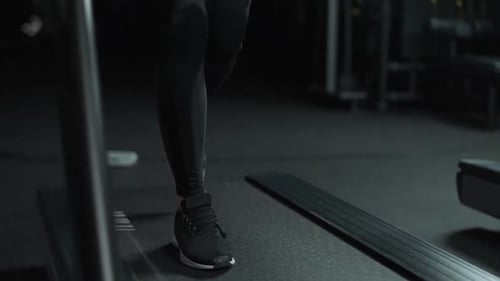 Female Athlete Run on a Treadmill Aerobic Exercise and Endurance Training in the Gym Slow Motion