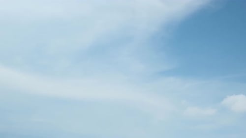 Gentle Clouds Floating in a Light Blue Sky