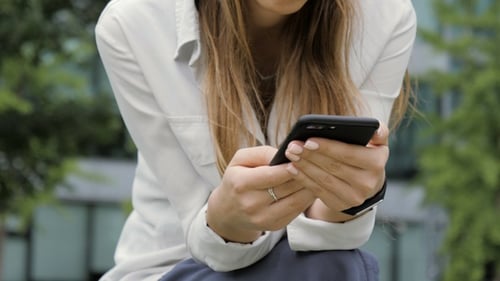 Woman Uses Smartphone in Urban Outdoor Setting