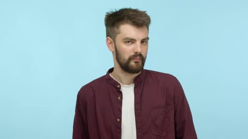Bearded Man Gesturing No on Blue Background