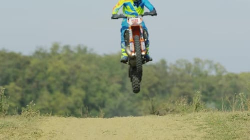 Motocross Rider Jumps High Into The Air