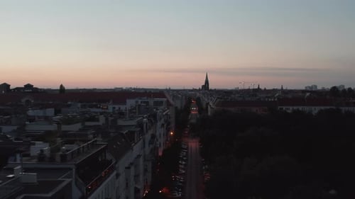 Forwards Fly Above Street in Urban Neighbourhood