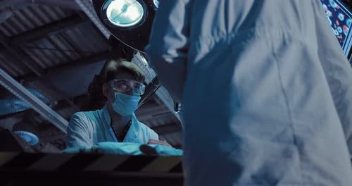 Futuristic Lab With Scientists Working in Dark Environment