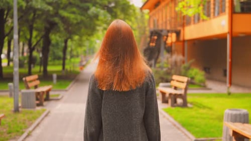 Girl with Beautiful Red Hair in Summer Park