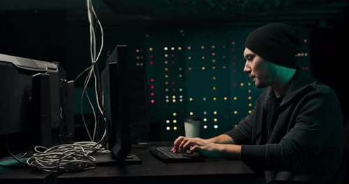 Focused Young Adult Typing on Computer Keyboard
