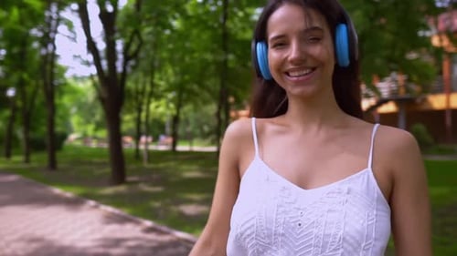 Woman Listening to Music in Green Park
