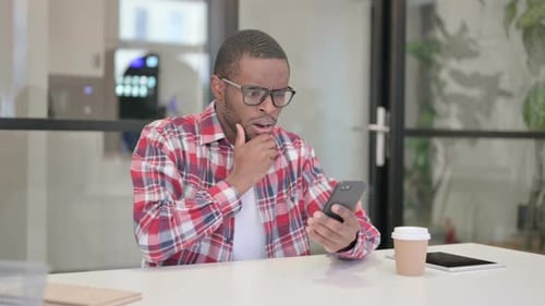 Young Adult Reacts to Shocking Content on Smartphone