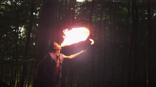 Man Breathes Huge Flames in a Dark Forest