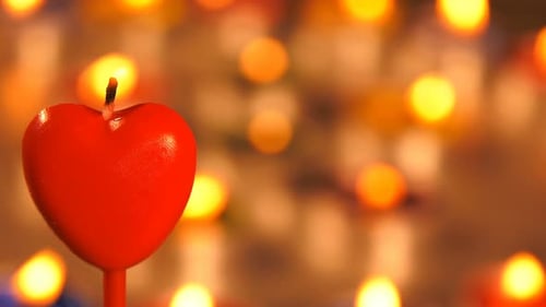 Burning Heart Candle with Bokeh Lights Background