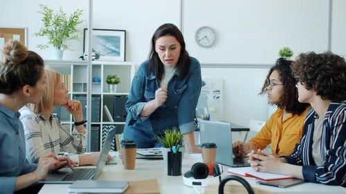 Business Lady Talking To Team of Female Professionals Discussing Work in Office