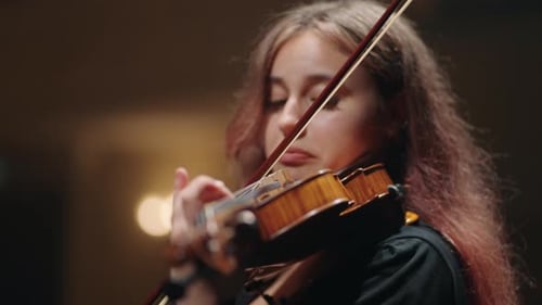 Pretty Female Violin Player is Playing Fiddle in Music Hall Portrait of Female Violinist in Opera