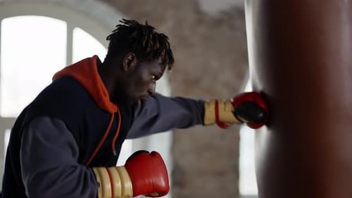 Male Boxer Training at Boxing Studio in Gloves