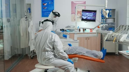 Dentists Treating Patient in Modern Dental Office