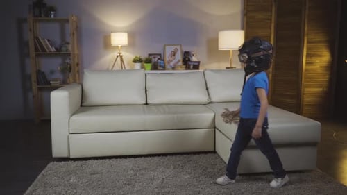 Child with Pilot Helmet Plays with Toy Airplane
