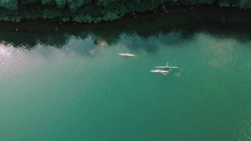 Wonderful Aerial Footage of Men Swimming in Kayak on Blue River Water. Drone View. Following High