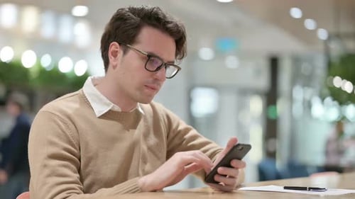 Man Using Smartphone in Office
