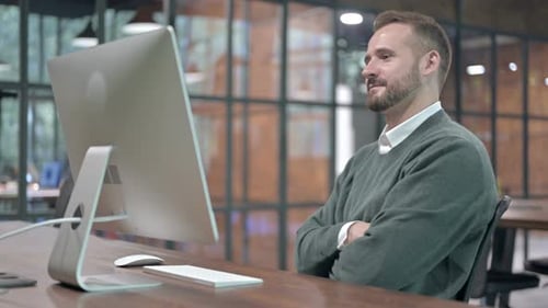 Working Man Smiling and Doing Video Chat on Computer