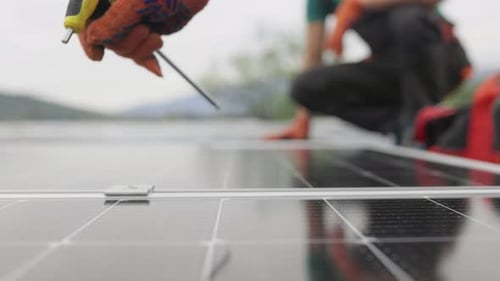Technicians Installing Solar Panels on Metal Stand
