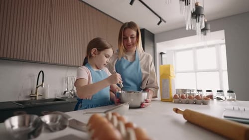Mother and Child Baking Together in Kitchen