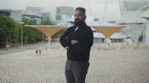 Confident Young Man Standing on Square with Crossed Arms