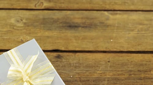 Gift Box and Roses on a Wood Surface