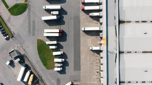 Different Trucks on Parking Site Near Huge Warehouse Aerial