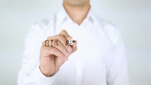 Man Writes Business Strategy on Clear Surface