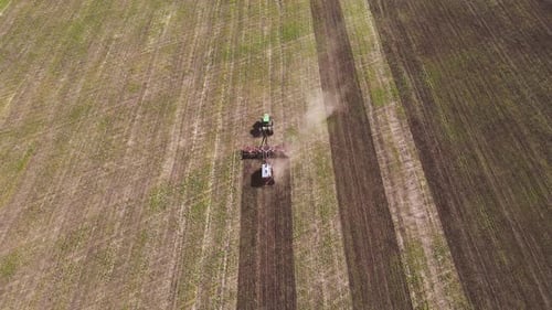 Tractor Tilling Field in Aerial Rural Scene