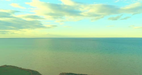 Aerial Hyperlapse of Sunset and Clouds Above Sea Coast. Timelapse Drone Fly Near Ocean Bank. High