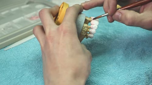 Painting Details on False Teeth in a Dental Lab