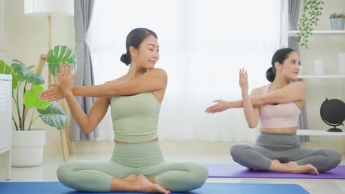 Asian active sport woman learn yoga pilates lesson with coach trainer for health care in house
