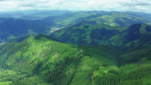 Aerial Drone View of Houses in the Green Forested Mountains.