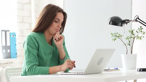 Woman Working on Laptop in Modern Office