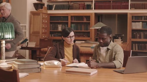 Student and Professor Studying in Library
