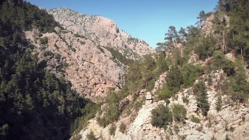 Flying over rocky mountains.