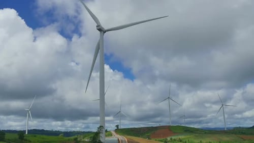 Wind Turbines Spinning on Green Hills, Daytime