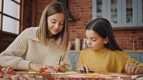 Adult and Child Drawing Together at Table