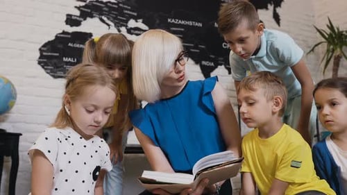Children Gather Around Teacher Reading a Book