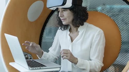 Woman Uses VR Headset at Modern Workplace