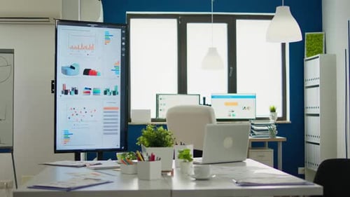 Bright Business Office Desk Ready for Morning Meeting with Financial Charts