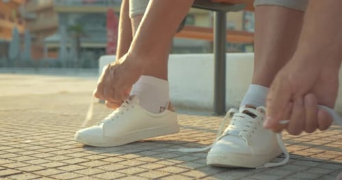 Mature couple lacing running shoes before jog