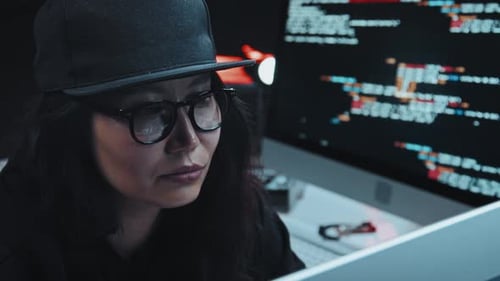 Woman Working at Night with Computer Code